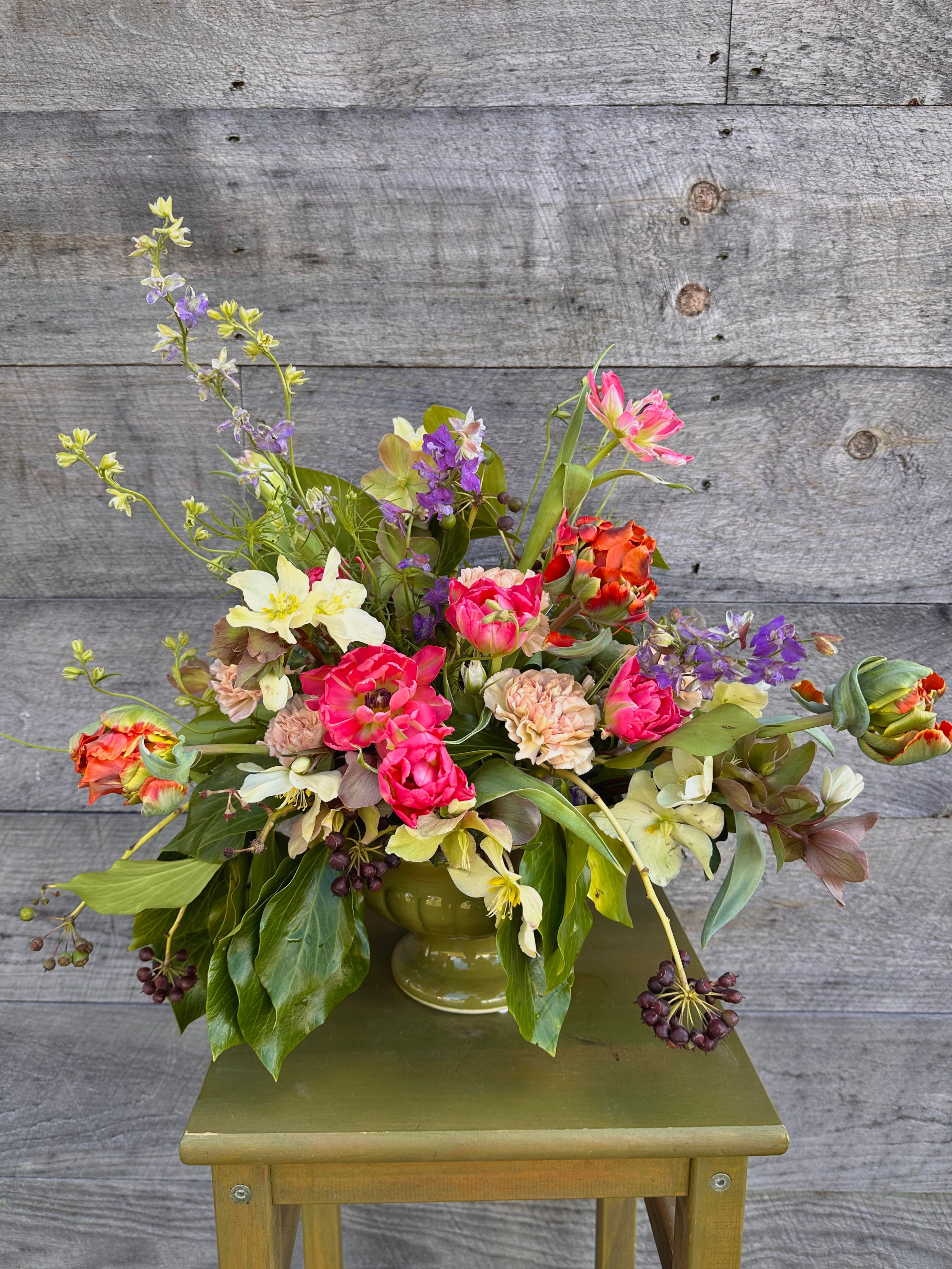 Large, whimsical compote arrangement with spring flowers
