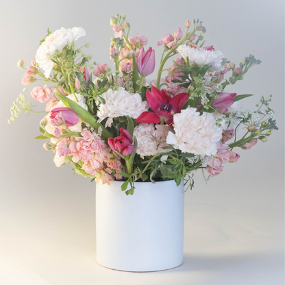 A large mixed bouquet featuring vibrant tulips and seasonal flowers arranged in a ceramic vase, perfect for Valentine’s Day.