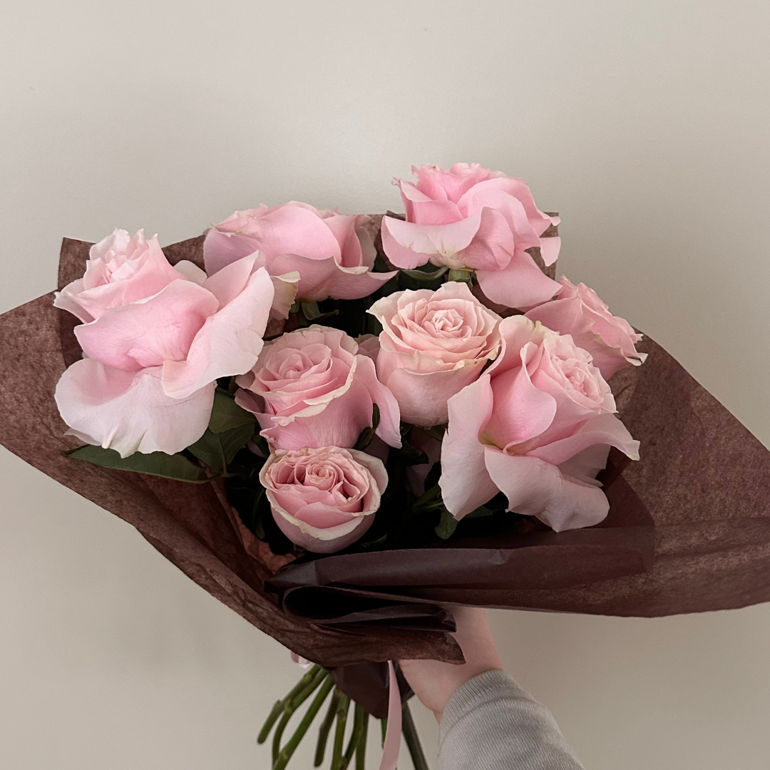 A bouquet of soft pink roses arranged elegantly, perfect for expressing love and affection this Valentine's Day.