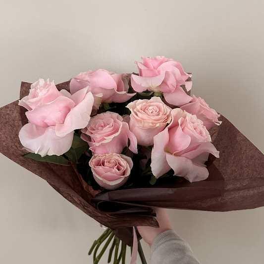 A bouquet of soft pink roses arranged elegantly, perfect for expressing love and affection this Valentine's Day.