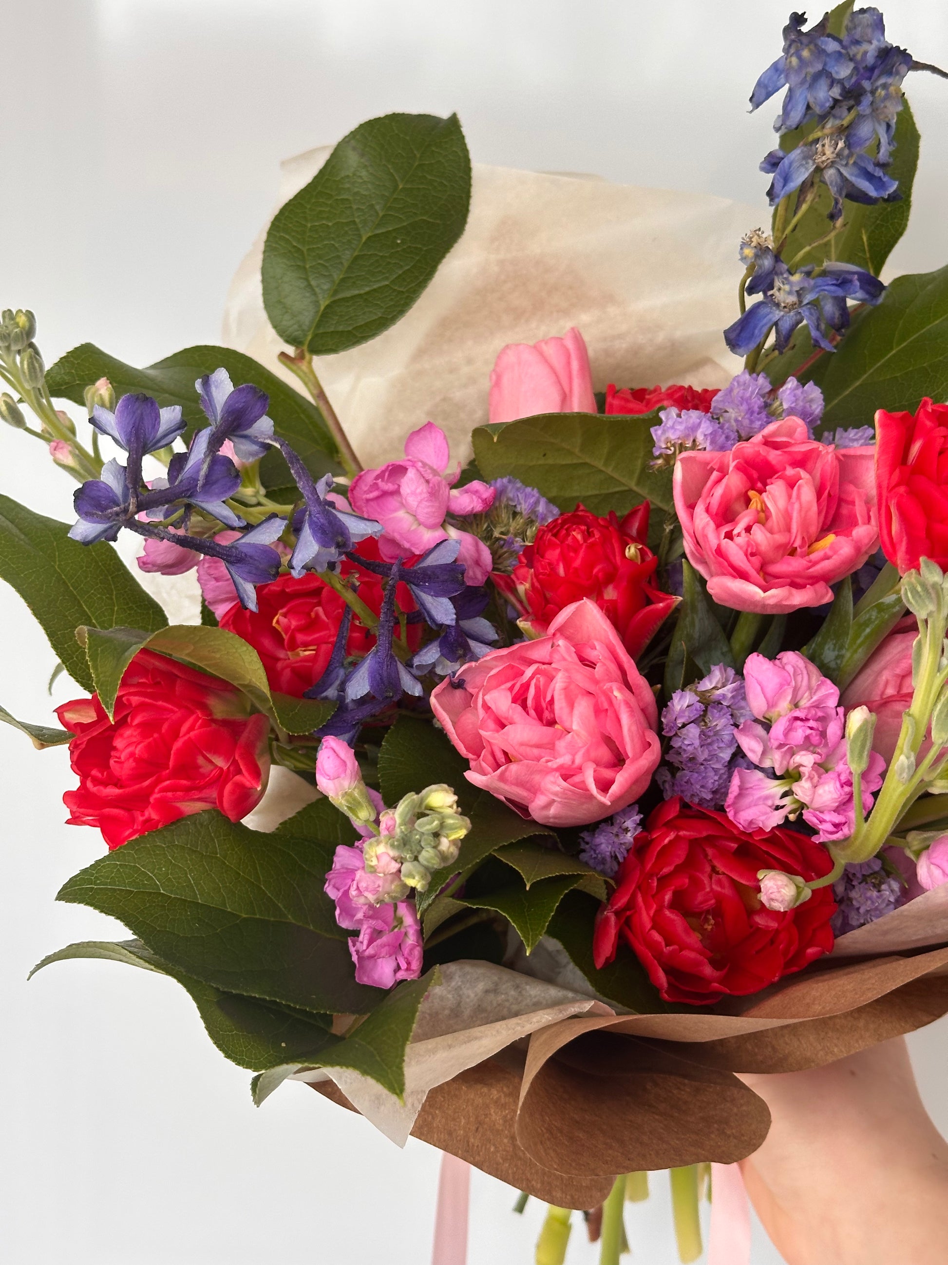 Standard wrapped bouquet featuring fresh seasonal flowers, wrapped in neutral tissue and brown kraft paper from Fonta Flora Flower Co.